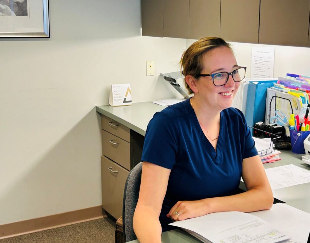 woman working at counter of dentist office